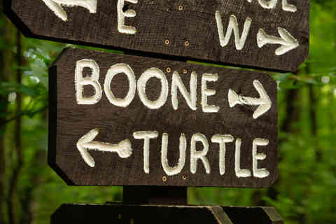 Wooden trail signs with woodland background at French Creek State Park in Elverson, Pennsylvania, USA.