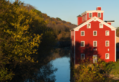 Old grist mill at sunrise on a beautiful Autumn morning.  Bellevue, Iowa, USA.