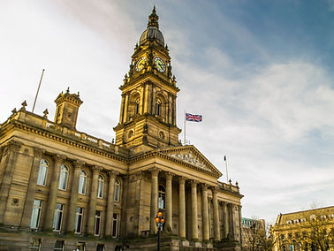 Sun lighting the clock tower on Bolton Town Hall.  Bolton, Greater Manchester, England.