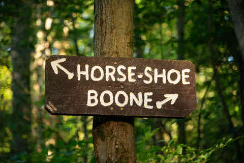Wooden trail signs with woodland background at French Creek State Park in Elverson, Pennsylvania, USA.