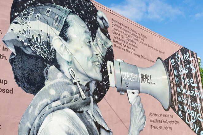 Mural titled "We Still Here!", by artist Chip Thomas aka Jetsonarama., in the Germantown neighborhood of Philadelphia, Pennsylvania, USA.