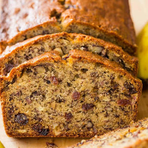 Sliced banana bread loaf on a wooden surface, ready to eat