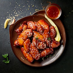 Firefly Tender chicken wings glazed with a sticky honey-garlic sauce, creating a perfect b