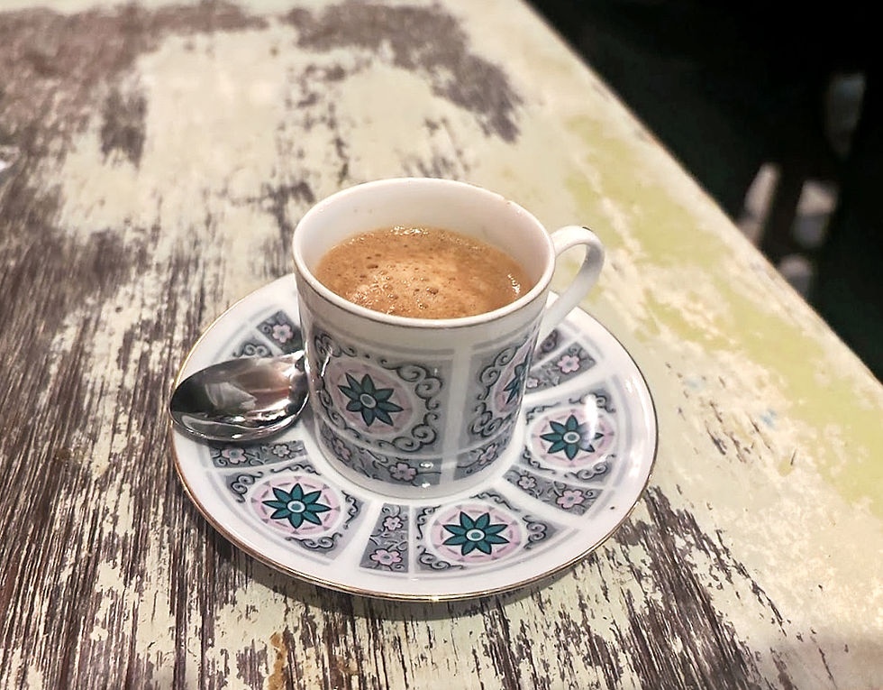 A tiny ornate cup of espresso, the quiet full stop at the end of the meal.