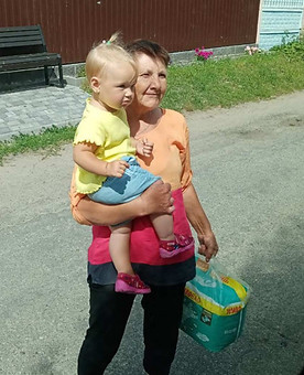 Woman holding her grandchild and donated nappies