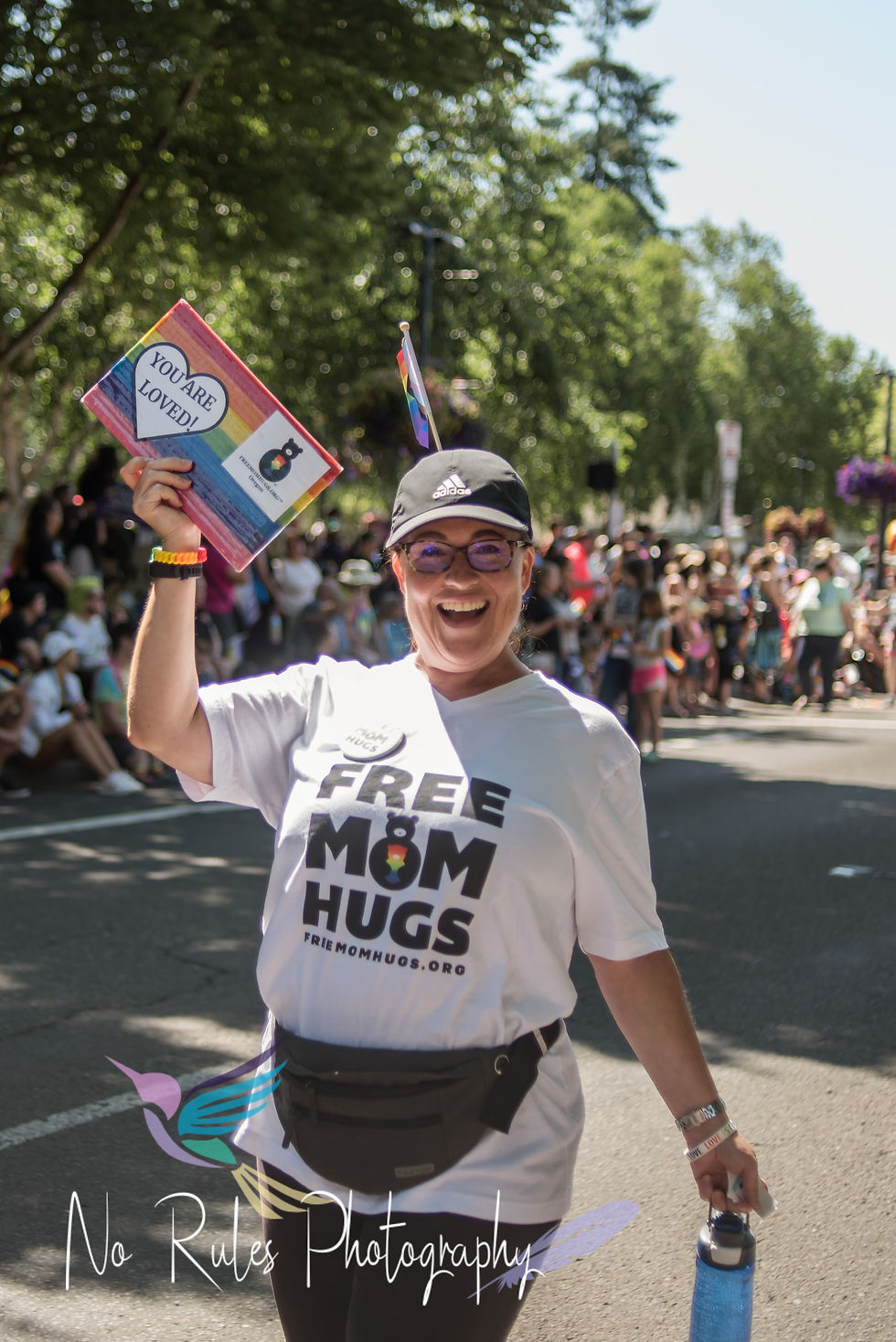 Beaverton Pride Festival and Parade shows parade participants walking in historic downtown Beaverton oregon