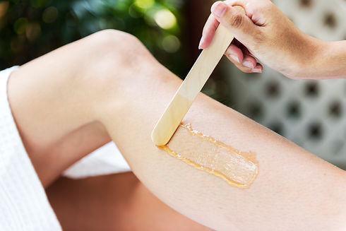 woman-getting-legs-waxed-at-a-spa-PFWLHK
