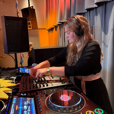 The DJ in headphones at the decks