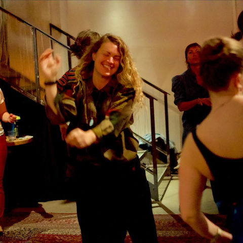 A dancer laughing on the dance floor