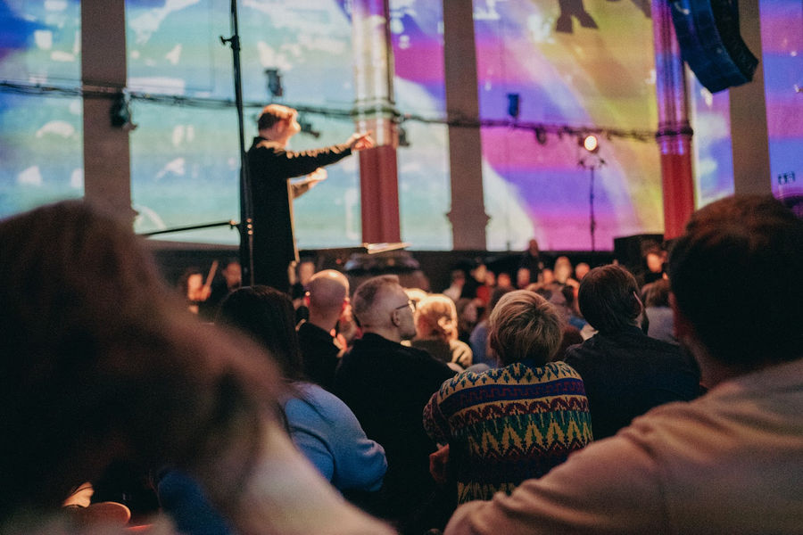 The audience under colourful projections