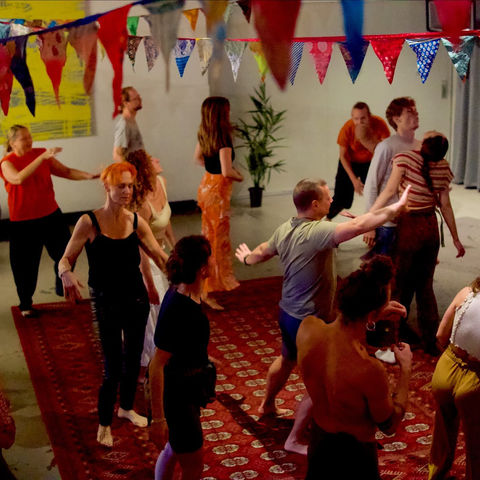 The dance floor seen from above, arms out and moving