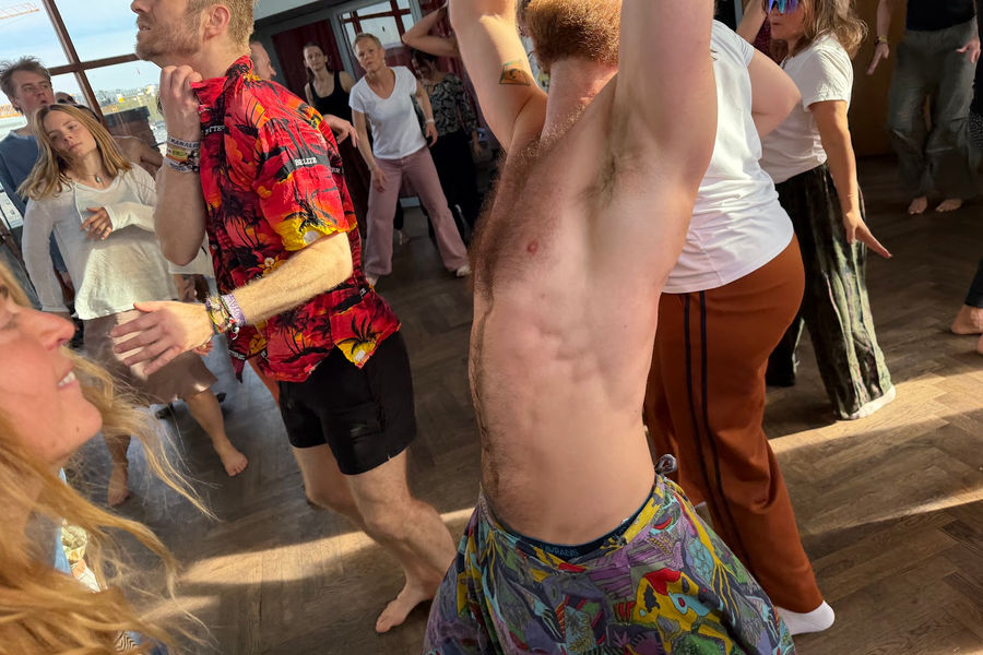 A dancer with his arms stretched up