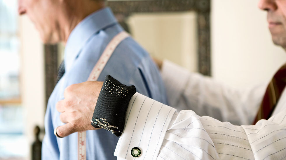 a tailor measuring a client