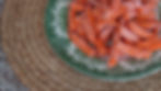 Frozen sweet potato fries on a green floral plate, placed on a woven mat. The setting is a speckled countertop. The mood is casual and rustic.