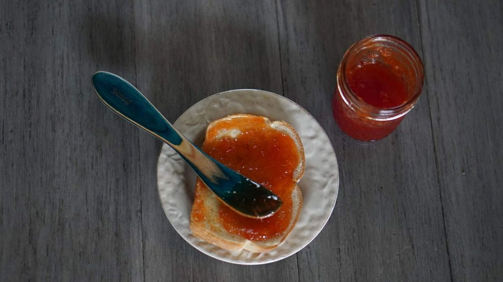 Tomato Jam spread over a piece of toast.