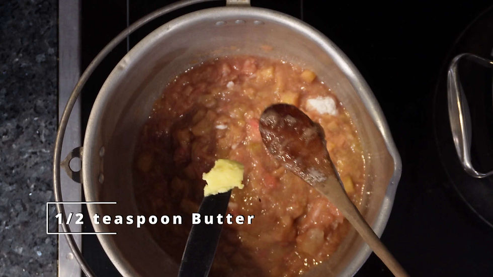 Pot of fruit mixture cooking on a stovetop, with a wooden spoon and knife adding 1/2 teaspoon butter. Text: "1/2 teaspoon Butter."