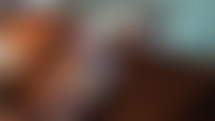 Festive garland of multicolored fabric strips and fairy lights draped over a wooden chest with metal bands, creating a cozy atmosphere.