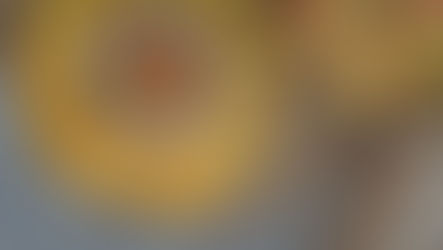 Bowl of vibrant corn salsa with red peppers on a plate of tortilla chips. Natural woven mat background, creating a rustic feel.