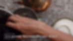 Hand placing blackberries in a bowl on a speckled countertop. Copper kettle and jars nearby. Text: "2-3 pounds Blackberries per Quart."