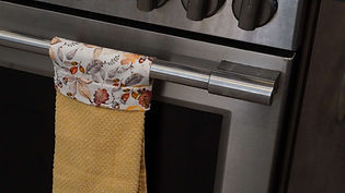 a simple sewing project that keeps a useful towel right where you need it while adding a charming handmade touch to the kitchen.