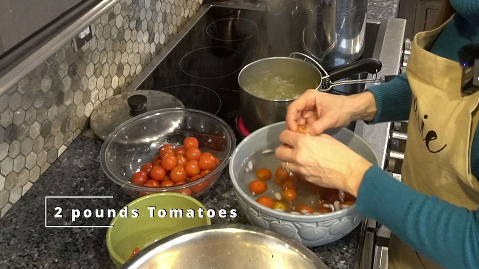 Person peeling tomatoes in a kitchen. Bowls of cherry tomatoes on a counter near a stove with boiling water. Text: 2 pounds Tomatoes.