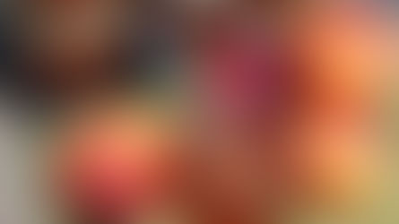 Jars of nectarine pineapple jam and fresh nectarines on a green cloth. A spoon rests in an open jar, capturing a rustic, homemade feel.