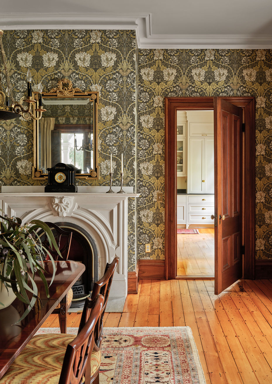 Little Compton dining room with fireplace, historic wallpaper, and restored wood details by Keene Architecture.