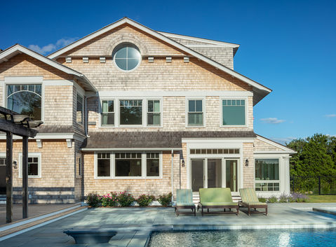 Shingle-style coastal home with pool and patio in Jamestown Rhode Island by Laurie Keene.