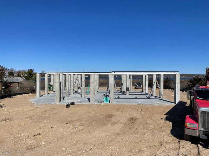 Concrete pier system supporting elevated coastal home.