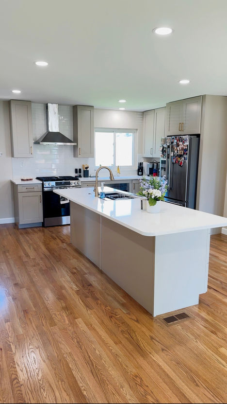 St. Louis kitchen remodel with quartz island, gold faucet, and stainless steel appliances