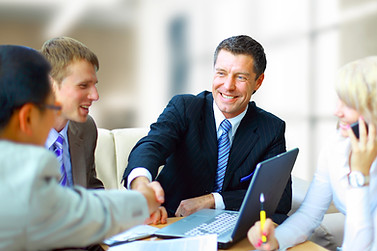 Three men and a woman having a financial investment business meeting