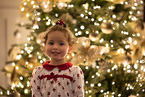 Lifestyle photography of a quiet indoor Christmas moment within childhood, shaped by warmth and imagination.
