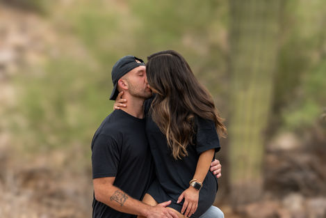 Engagement photography capturing natural connection and shared moments between a couple in an outdoor desert setting.