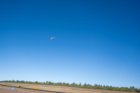 Aerial views of desert landscapes, mountain ridges, waterways, and a small aircraft, including runway and in-flight images.