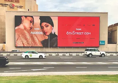 “Large roadside billboard advertising 6thStreet.com with fashion models and the message Think Fashion"