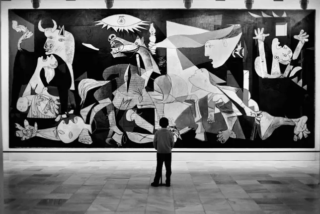 A child admiring Guernica by Pablo Picasso at the Reina Sofia Museum