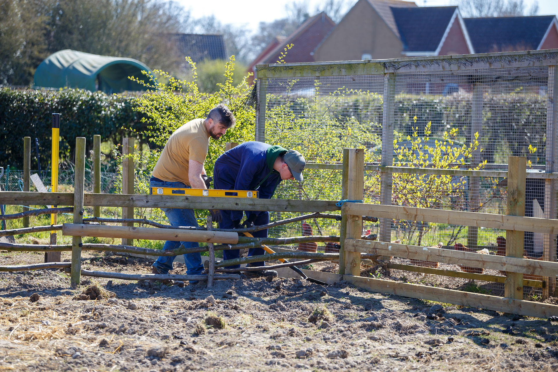 pathways members working on a fence