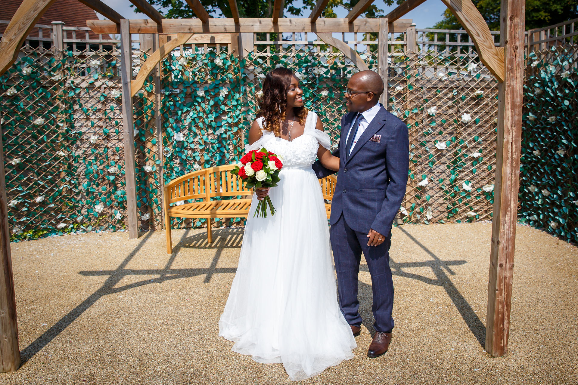 bride and groom looking towards each other posing at Cambridge Register Office on Ascham road