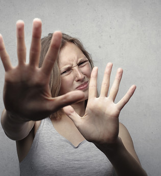 woman-in-gray-tank-top-looking-frightene