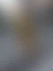 Black model wearing a long yellow dress, posing on the streets.