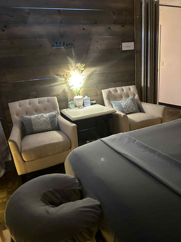 Full view with two chairs and a table in the middle with a lamp