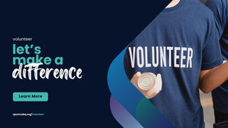 Person wearing a Volunteer Shirt handing out cans of goods.