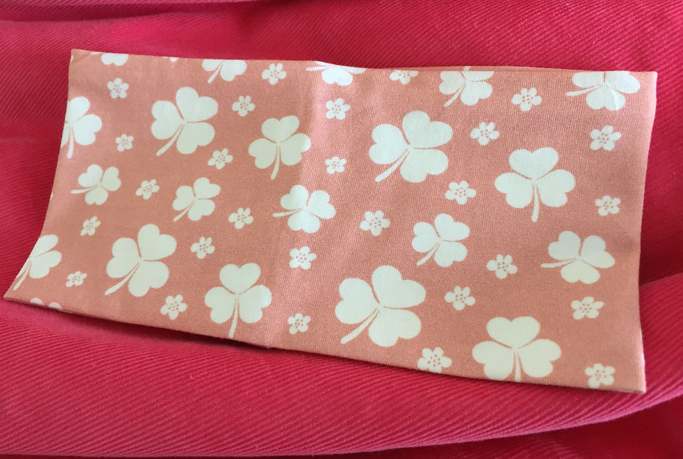 lyserosa pannebånd med kløver. Unike, fargerike barneklær og luer håndlaget av Urk!