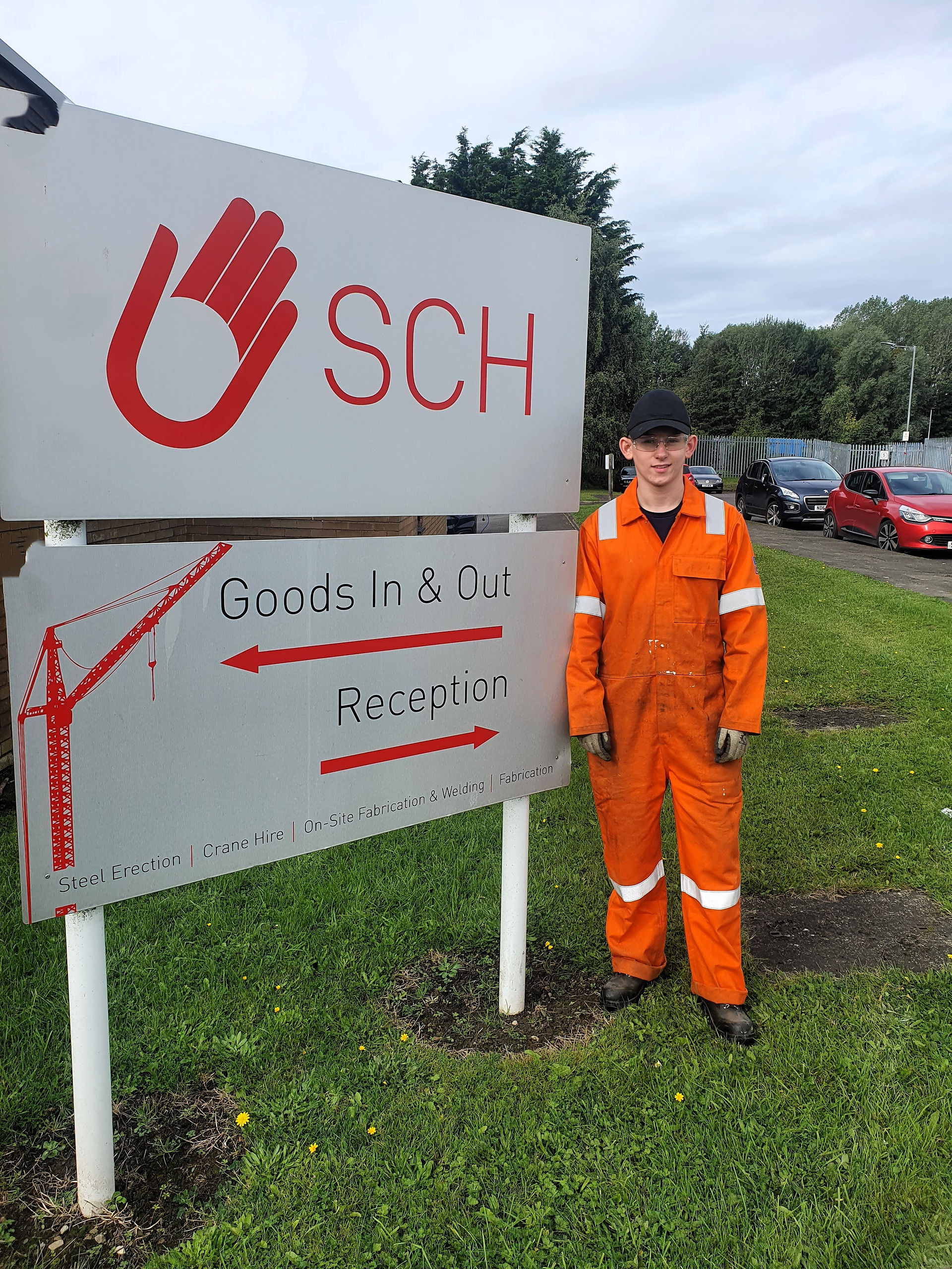 Jake next to the sch sign