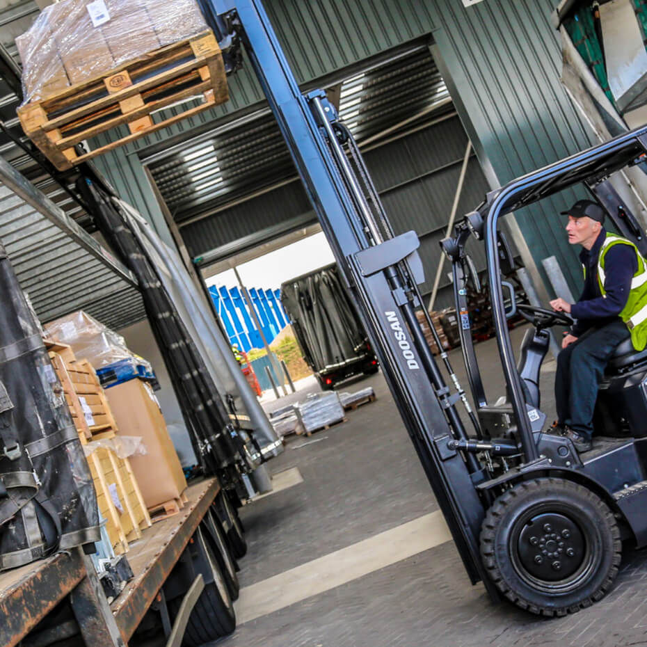 Person operating a forklift at a loading dock