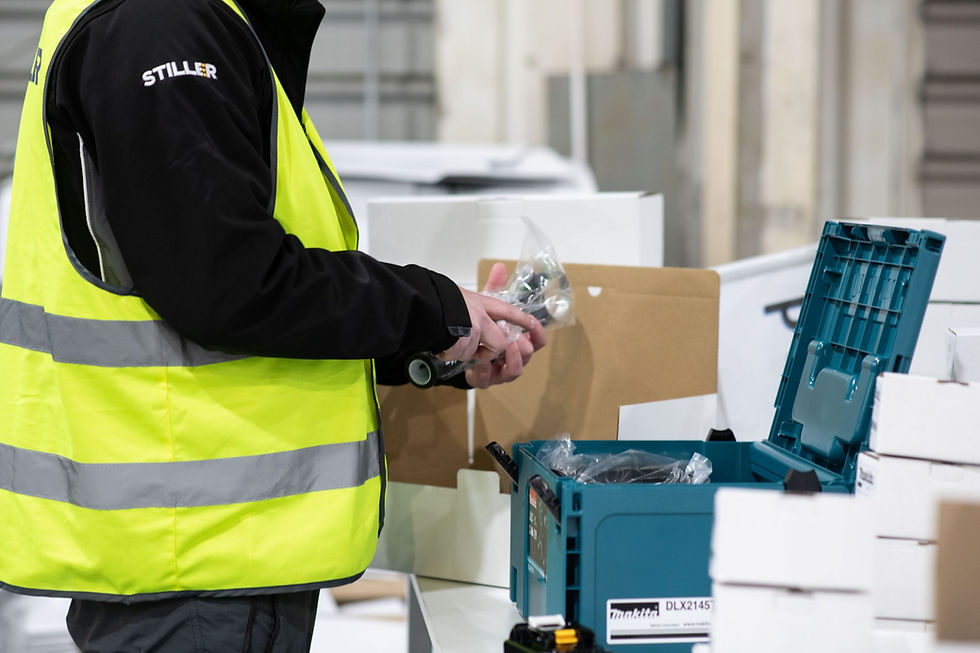 Worker in high-vis vest packing small components