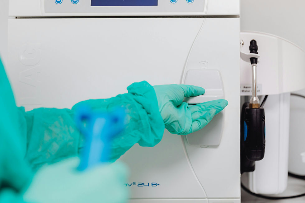 Gloved hand operating a white medical device in a lab setting. The machine displays "24 B+" with blue accents. Clean, clinical mood.