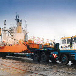 Stiller truck transporting large ship component