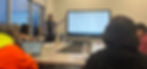 High angle view of a training session with a laptop and digital learning materials