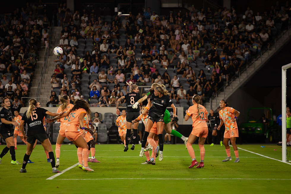 Angel City FC and Orlando Pride players battle for the ball in front of goal during a tense NWSL match.